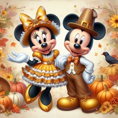 two mickey and minnie mouses dressed up in thanksgiving costumes standing next to each other