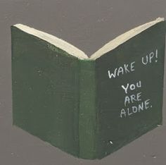 a green book with writing on it that says wake up you are alone