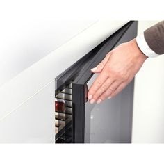 a person is holding the door to an oven with its right hand on it's side