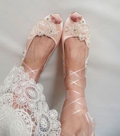 "For your wedding day, look no further than these bespoke blush flat shoes with ivory lace and crystals. These elegant bridal flats with ballerina ties are the perfect finishing touch for your romantic wedding day look. A unique mix of silver crystals, sparkly beads and sequins make up the delicate pattern of the floral lace. Wedding flats with 1\" kitten heels promise to keep you comfortable all night long. Blush satin flat wedding shoes are designed with embroidered lace appliques. Glass beads, shiny sequins and silver crystals are used on the embroidery. Organza ribbons can be tied as a bow on the front, or around your ankle like a ballerina style. Bespoke bridal shoes are also a perfect custom wedding gift. They are made of soft satin and delicate lace, each handmade item is unique and Luxury Embellished Wedding Flats, Festive Embellished Wedding Flats, Embellished Slip-on Party Wedding Shoes, Blush Bridal Shoes Flats, Lace Wedding Flats, Elegant Embellished Slip-on Flats, Embroidery Organza, Flat Wedding Shoes, Blush Shoes