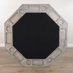 a black and white drawing of a circular object on wood flooring in an empty room