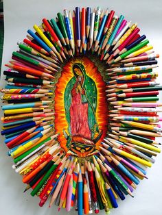 an image of the virgin mary surrounded by colored pencils