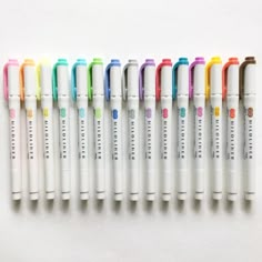 six pens lined up in a row on top of each other, with different colors