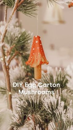 an ornament hanging from a pine tree with the words diy egg carton mushrooms