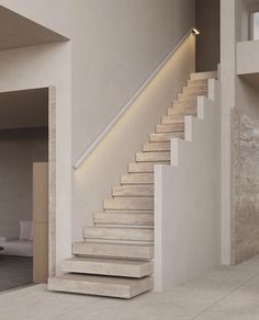 there is a white stair case in the living room with beige walls and flooring