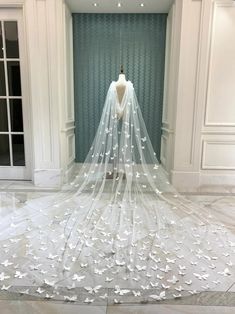 a white wedding dress on display in a room