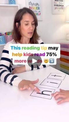 a woman sitting at a table with a sign that says help kids read 75 % more