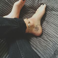 a woman's foot with a tattoo on it