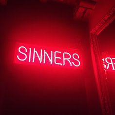 a red neon sign that says sinners on it