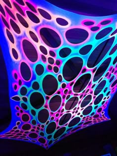 an artistic light sculpture in the shape of a square with circles and dots on it