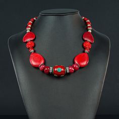 This unusual red Necklace is 20 1/4" long made with a Tibetan oval centerpiece of Enamel and Turquoise (30x20mm) framed with 4 faceted red Jade rondels, red  Howlite ovals and hearts and Tibetan red , silver ended 9mm decorative beads to frame the Sterling lobster clasp (10x20mm) Red Round Beads Stone Jewelry, Red Jewelry With Round Beads And Stones, Red Round Beaded Stone Jewelry, Red Gemstone Necklace For Valentine's Day, Red Gemstone Round Necklace, Elegant Red Beaded Necklaces With Stones, Elegant Red Beaded Necklace With Stones, Red Round Gemstone Necklace, Red Polished Beads Round Jewelry