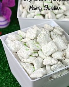 fairy dust pistachio muddy buddies in white containers on green grass with butterfly decorations