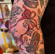 a woman's arm with tattoos on it and a bow around the wrist is shown