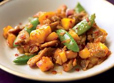 a white plate topped with meat and veggies