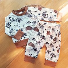 Oh my goodness, have you seen this adorable Baby Boys Boho Rainbow 2-Piece Set? It's seriously the cutest thing ever! This outfit features an overall boho rainbow pattern. It has an elastic waistband and brown arm and leg cuffs. It's so soft and cozy, your little one will never want to take it off. Plus, it's perfect for play time on warmer days. Trust me, you need this cute 2-piece in your baby's wardrobe! Made with 35% cotton and 65% polyester. Wash cold with like colors.  View my other listings of more baby outfits to complete a look! Timeless and stylish baby apparel, carefully curated for your little one on Martha's Vineyard. Follow me on Instagram @vineyardmamaco to see new items and flash sale announcements! Baby Boys Outfit, Brown Rainbow, Jogger Outfit, Rainbow Outfit, Outfit Cute, Joggers Outfit, Martha's Vineyard