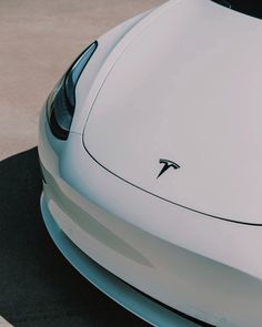 the front end of a white sports car