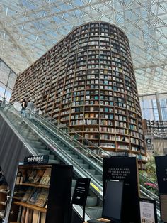 an escalator in a large building filled with books