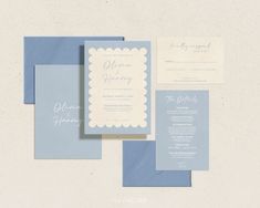 the wedding stationery is laid out on top of each other