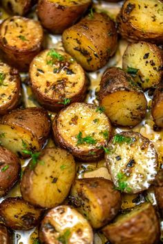 cooked potatoes with parsley on top in a baking dish, ready to be eaten