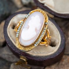 an oval shaped ring with pearls and a mother's day stone