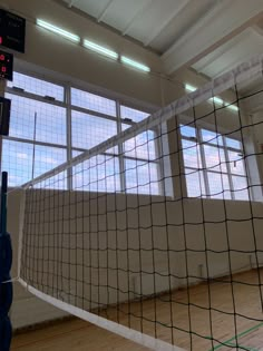 an indoor volleyball court with net and ball