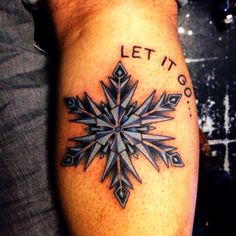 a snowflake tattoo that says let it go