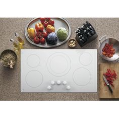 an overhead view of a stove top with vegetables on it