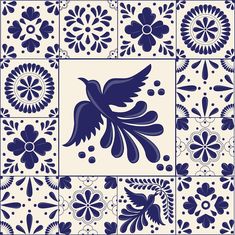 a blue and white tile design with flowers, leaves and birds in the center stock photo