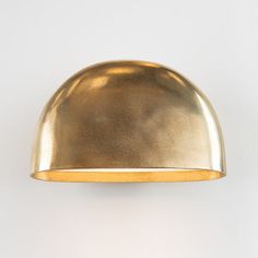 a gold dome light on a white wall