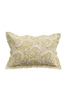 a yellow and white pillow with an intricate design on the front, sitting against a white background