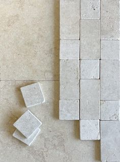 some white tiles are laying on the floor