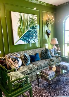 a living room filled with furniture and green walls