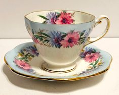 a tea cup and saucer decorated with flowers