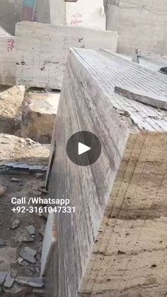 a man riding a skateboard down the side of a wooden ramp at a construction site