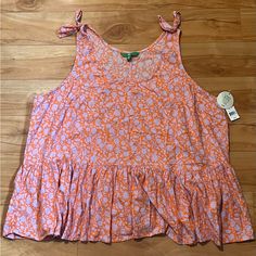 an orange and pink top on a wooden floor