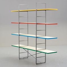 a multicolored metal shelf with three shelves on each side and two benches below