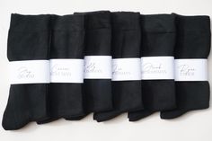 five pairs of black socks with white labels on them