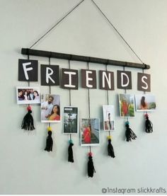 a group of friends hanging on a wall with pictures and tassels attached to it