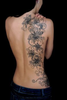 the back of a woman's body with flowers on it