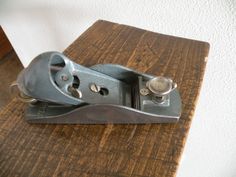 a metal object sitting on top of a wooden table