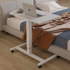 a bed with a laptop on top of it