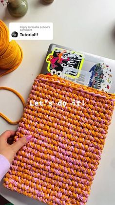 someone is making a book cover out of yarn