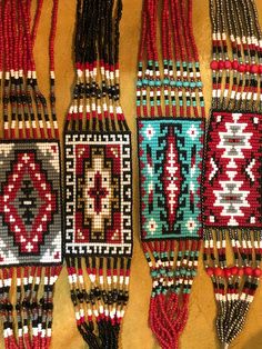 several beaded bracelets are hanging on a wall