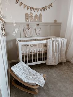 a baby's room with a rocking chair and crib