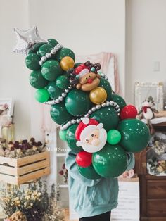 a person holding up a bunch of balloons