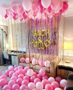 balloons and streamers decorate the entrance to a baby shower