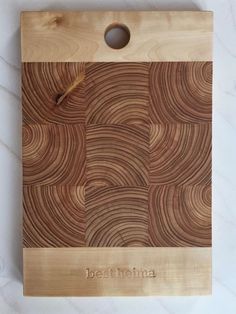 a wooden cutting board with the name bestfohna on it and an oval hole in the middle