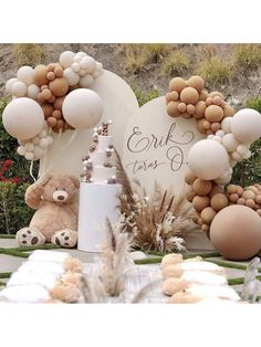 a table topped with balloons and teddy bears next to a sign that says bridal