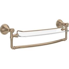 an antique brass finish toilet paper holder with two glass shelves