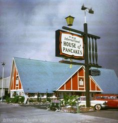 a red and white building with a sign that says house of pancakes in front of it